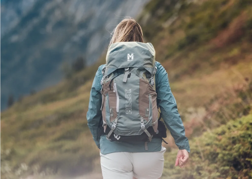 une femme qui randonne avec un sac à dos millet
